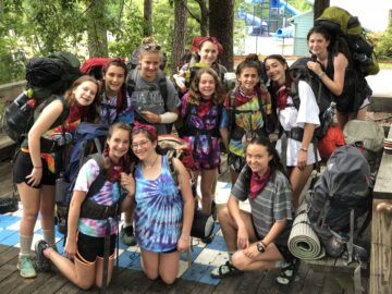 A group of campers and staff prepare to go on a backpacking trip