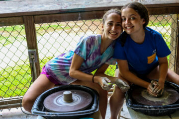 Campers making ceramics on pottery wheels